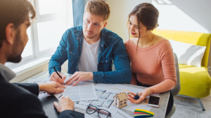 couple signing a buying a house contract